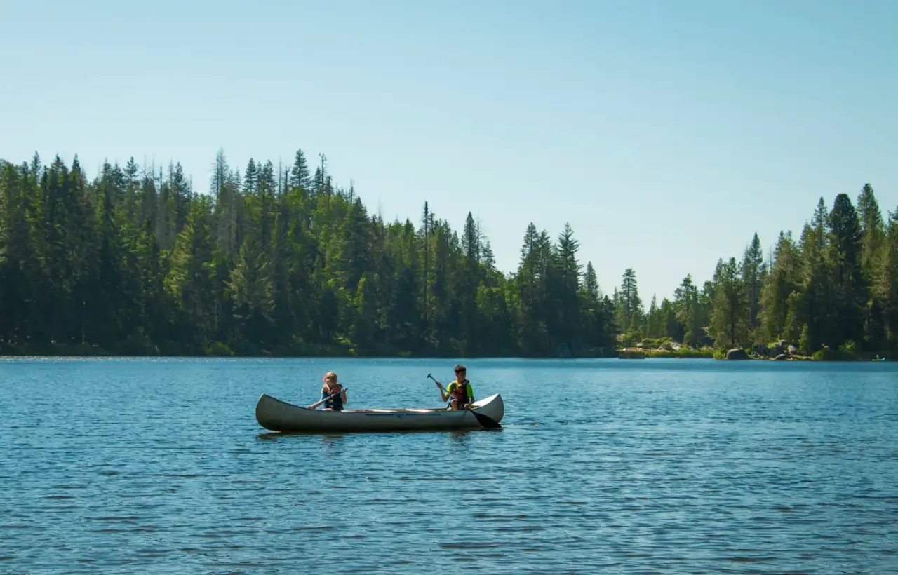 Paddlers in a canoe on calm water