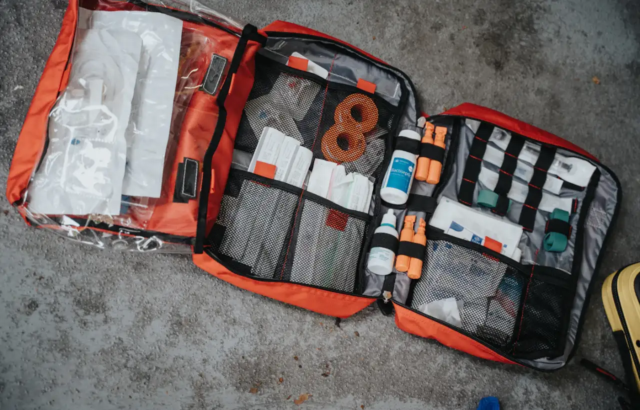 An open first-aid kit with bandages and medical supplies